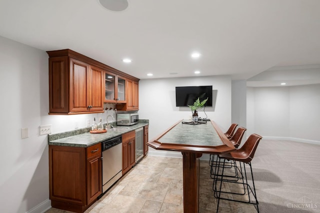 9317 E Kemper Rd, Symmes Twp, OH 45140 - kitchen featuring stainless steel appliances, beverage cooler, recessed lighting, glass insert cabinets, and brown cabinets