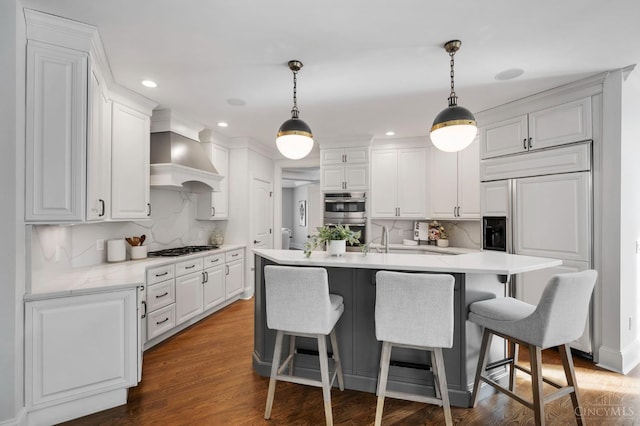 9317 E Kemper Rd, Symmes Twp, OH 45140 - kitchen with appliances with stainless steel finishes, wall chimney range hood, decorative backsplash, white cabinets, and light countertops