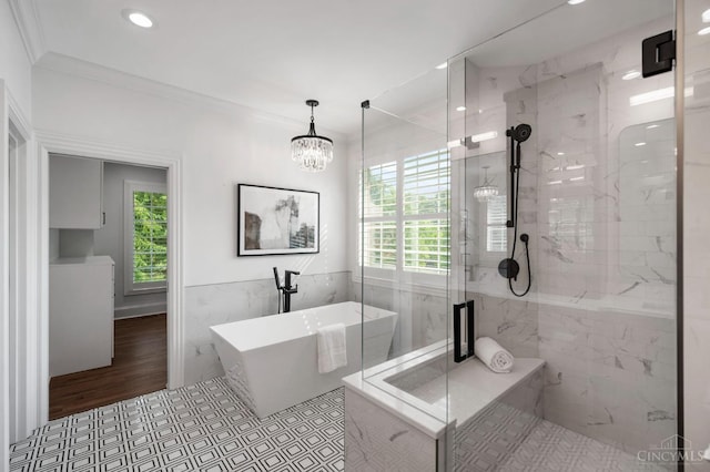 9317 E Kemper Rd, Symmes Twp, OH 45140 - full bath featuring tile walls, a freestanding bath, a marble finish shower, ornamental molding, and recessed lighting