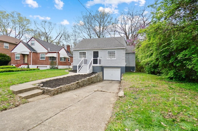 5521 Chandler St, Cincinnati, OH 45227 - bungalow with concrete driveway, a garage, and a front lawn