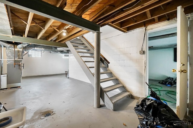 5521 Chandler St, Cincinnati, OH 45227 - below grade area with stairway, heating unit, and concrete block wall