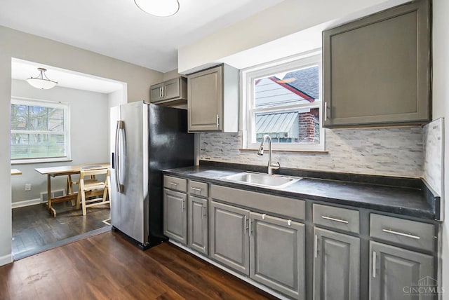 5521 Chandler St, Cincinnati, OH 45227 - kitchen featuring gray cabinetry, dark countertops, stainless steel refrigerator with ice dispenser, and backsplash