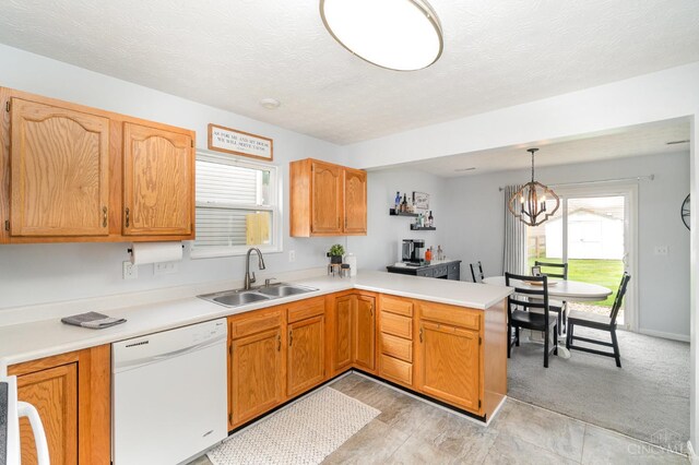 5985 Marsh Cir, Goshen Twp, OH 45140 - kitchen with white dishwasher, a peninsula, light countertops, a chandelier, and a textured ceiling