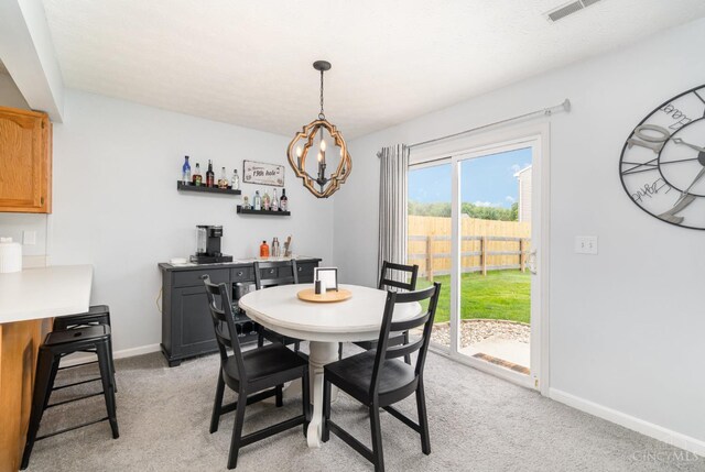 5985 Marsh Cir, Goshen Twp, OH 45140 - dining room with a bar, light colored carpet, and a chandelier