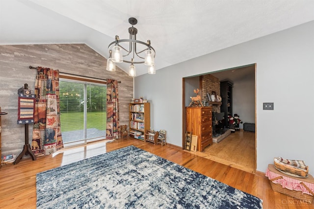648 Odenwald Dr, Perry Twp, OH 45118 - living area with a chandelier, wood finished floors, and vaulted ceiling