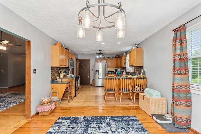 648 Odenwald Dr, Perry Twp, OH 45118 - kitchen featuring appliances with stainless steel finishes, dark countertops, and light wood-style flooring