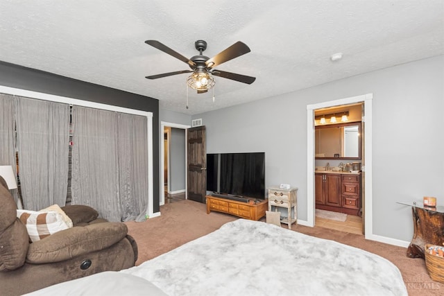 648 Odenwald Dr, Perry Twp, OH 45118 - bedroom with carpet flooring, a closet, a ceiling fan, ensuite bathroom, and a textured ceiling