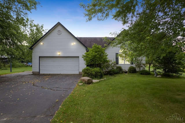 648 Odenwald Dr, Perry Twp, OH 45118 - view of front of house with driveway, a front yard, and an attached garage