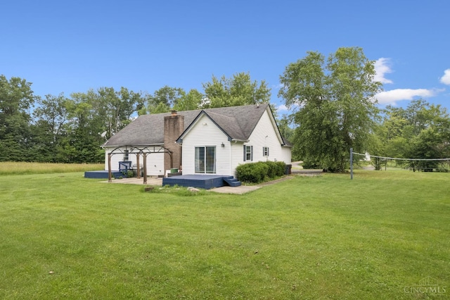 648 Odenwald Dr, Perry Twp, OH 45118 - rear view of house with a lawn, a chimney, a gazebo, and volleyball court