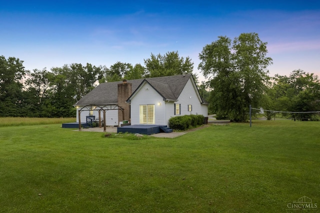 648 Odenwald Dr, Perry Twp, OH 45118 - back of property with a lawn, a chimney, and view of scattered trees