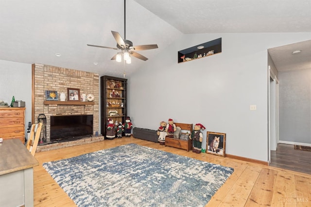 648 Odenwald Dr, Perry Twp, OH 45118 - living room featuring vaulted ceiling, a ceiling fan, wood-type flooring, and a brick fireplace