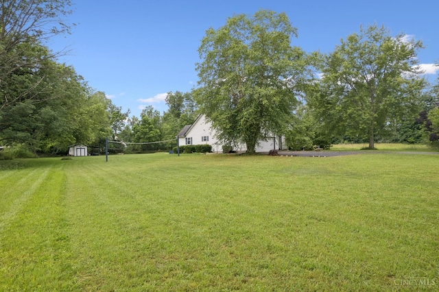 648 Odenwald Dr, Perry Twp, OH 45118 - view of grassy yard with a shed, a garage, and asphalt driveway