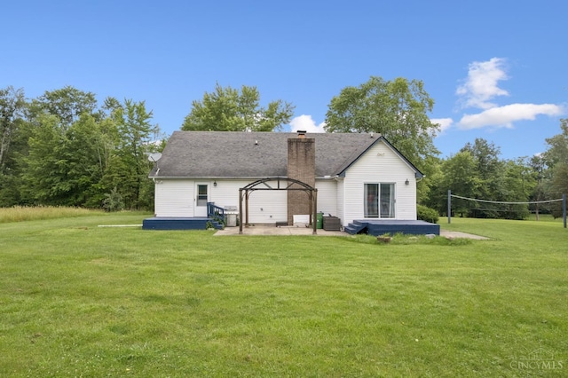 648 Odenwald Dr, Perry Twp, OH 45118 - back of property with a lawn, a chimney, and a patio area