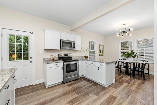 6213 Coleridge Ave, Cincinnati, OH 45213 - kitchen with appliances with stainless steel finishes, a peninsula, light wood-style flooring, a chandelier, and beamed ceiling