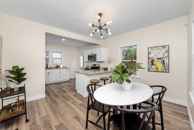 6213 Coleridge Ave, Cincinnati, OH 45213 - dining room featuring a chandelier and light wood finished floors