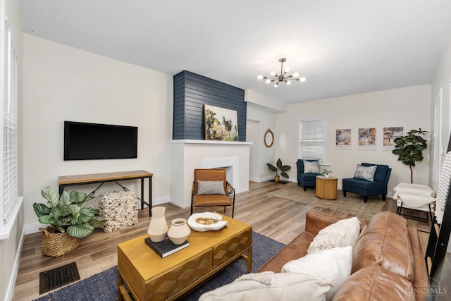 6213 Coleridge Ave, Cincinnati, OH 45213 - living room with wood finished floors, a chandelier, and a fireplace