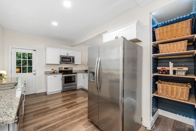 6213 Coleridge Ave, Cincinnati, OH 45213 - kitchen with stainless steel appliances, dark wood-type flooring, light stone counters, white cabinetry, and recessed lighting
