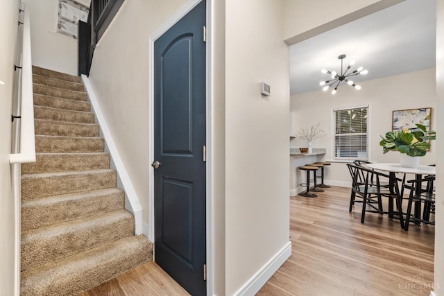 6213 Coleridge Ave, Cincinnati, OH 45213 - stairs featuring wood finished floors and a chandelier