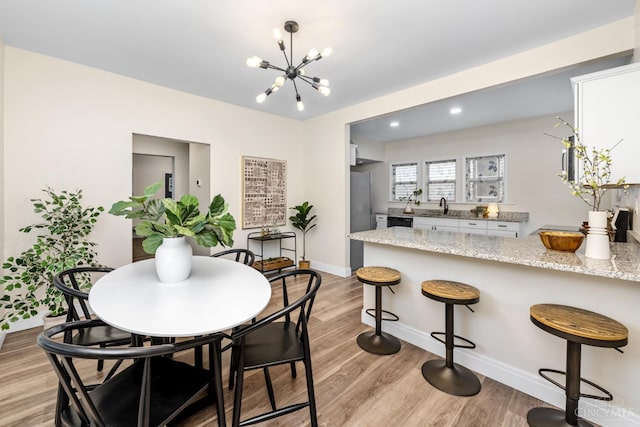 6213 Coleridge Ave, Cincinnati, OH 45213 - dining area featuring a chandelier and light wood-type flooring