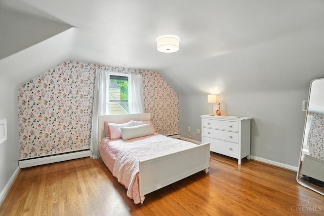 3862 Settle Rd, Mariemont, OH 45227 - bedroom featuring baseboard heating, lofted ceiling, and wood finished floors