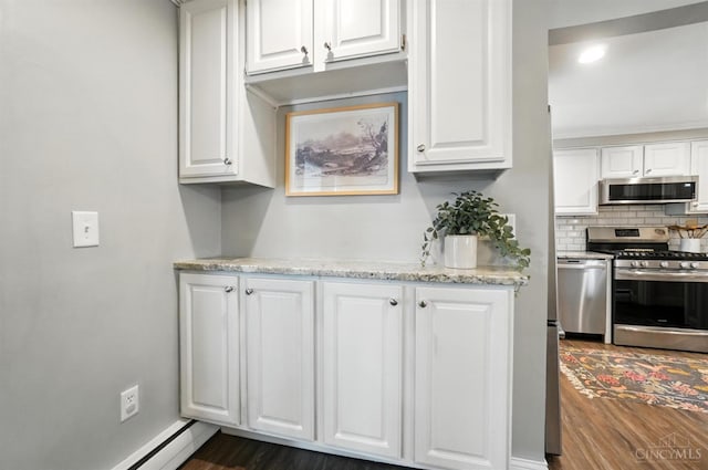 3862 Settle Rd, Mariemont, OH 45227 - kitchen with stainless steel appliances, white cabinets, backsplash, dark wood-type flooring, and recessed lighting