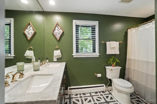 3862 Settle Rd, Mariemont, OH 45227 - full bathroom featuring baseboard heating, double vanity, tile patterned flooring, recessed lighting, and curtained shower