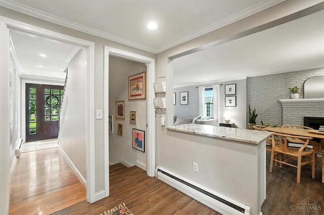 3862 Settle Rd, Mariemont, OH 45227 - kitchen with a baseboard heating unit, wood finished floors, ornamental molding, a fireplace, and light stone countertops