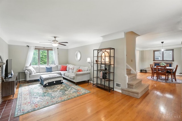 6159 Tulane Rd, Cincinnati, OH 45212 - living room with stairway, wood finished floors, and ceiling fan