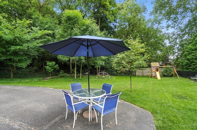 6159 Tulane Rd, Cincinnati, OH 45212 - fenced backyard with a patio area, a playground, outdoor dining area, and view of scattered trees