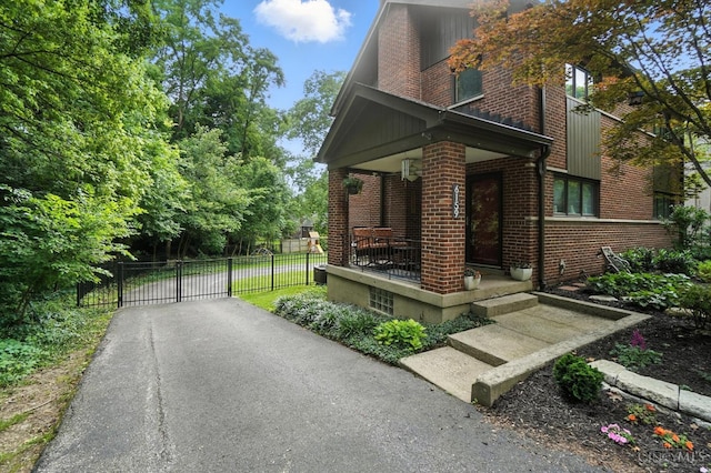 6159 Tulane Rd, Cincinnati, OH 45212 - view of front of home with brick siding, a gate, and a porch