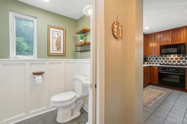 6159 Tulane Rd, Cincinnati, OH 45212 - bathroom featuring tile patterned floors, backsplash, a wainscoted wall, vanity, and a decorative wall