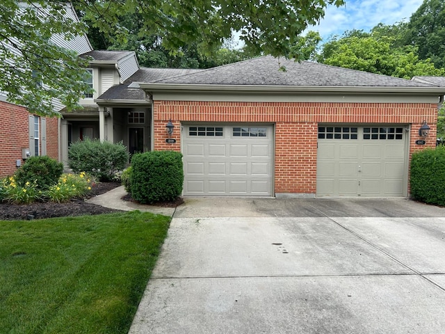 4989 Lord Alfred Ct, Sharonville, OH 45241 - view of front facade featuring an attached garage, driveway, brick siding, a shingled roof, and a front lawn