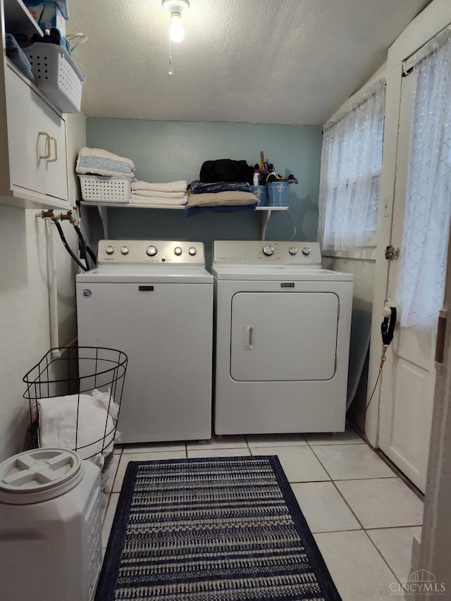 316 W S St, Hillsboro, OH 45133 - washroom with washing machine and dryer, a textured ceiling, cabinet space, and light tile patterned flooring