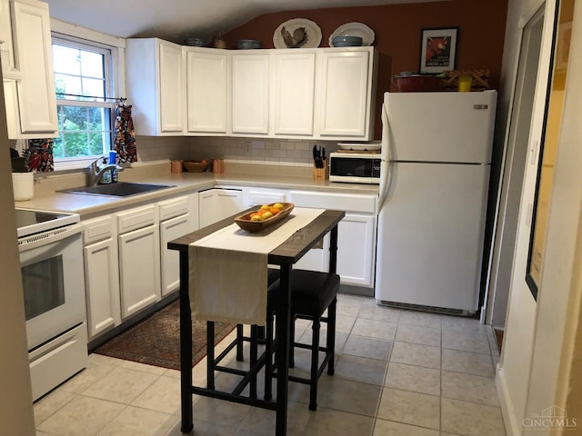 316 W S St, Hillsboro, OH 45133 - kitchen with white appliances, tasteful backsplash, light countertops, white cabinetry, and vaulted ceiling
