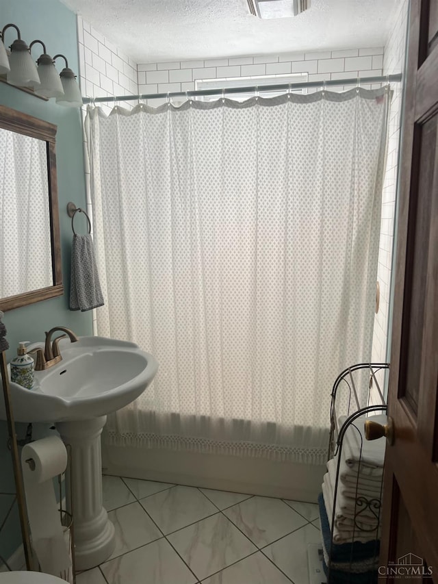 316 W S St, Hillsboro, OH 45133 - full bathroom featuring a textured ceiling, shower / bath combo with shower curtain, and marble finish flooring