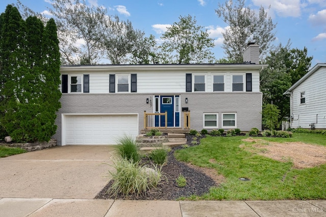 1407 Southwind Dr, Mason, OH 45040 - split foyer home with an attached garage, brick siding, concrete driveway, a chimney, and a front yard