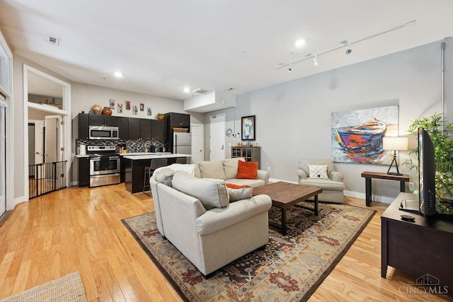 1150 Vine St Unit 15, Cincinnati, OH 45202 - living room featuring light wood-style flooring, recessed lighting, and track lighting