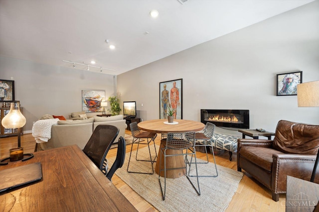 1150 Vine St Unit 15, Cincinnati, OH 45202 - dining area with light wood-type flooring, a glass covered fireplace, track lighting, and recessed lighting