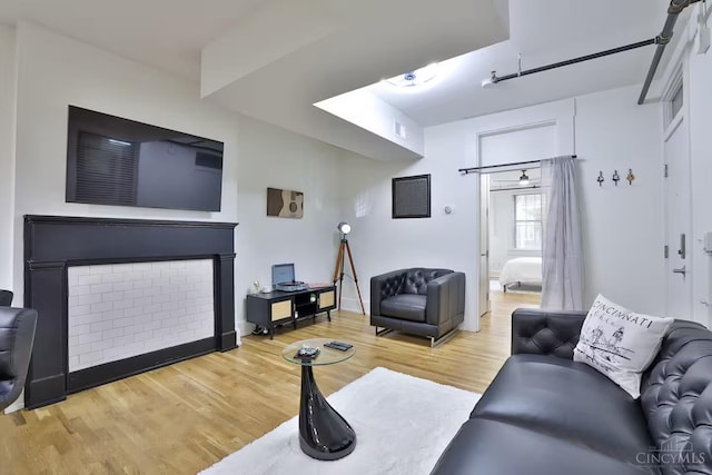 1407 Vine St Unit 203, Cincinnati, OH 45202 - living area with wood finished floors and a fireplace