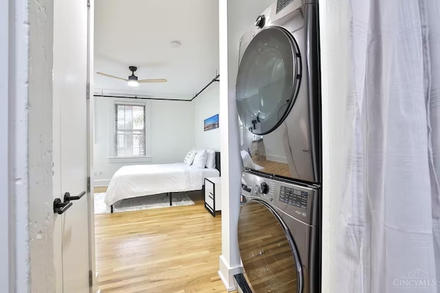 1407 Vine St Unit 203, Cincinnati, OH 45202 - washroom with stacked washer / drying machine, light wood-style flooring, and ceiling fan