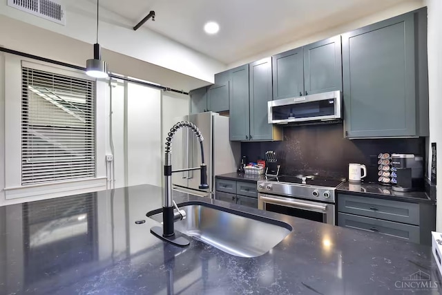 1407 Vine St Unit 203, Cincinnati, OH 45202 - kitchen with appliances with stainless steel finishes, hanging light fixtures, dark stone countertops, and recessed lighting