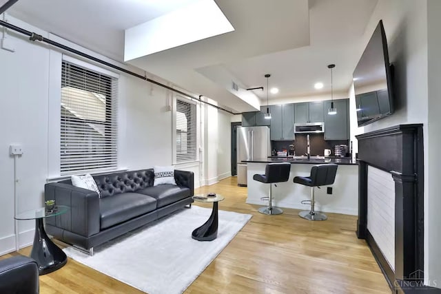 1407 Vine St Unit 203, Cincinnati, OH 45202 - living area with light wood-style floors and recessed lighting