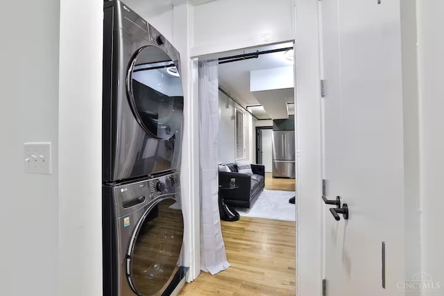 1407 Vine St Unit 203, Cincinnati, OH 45202 - laundry room featuring estacked washer and dryer and wood finished floors
