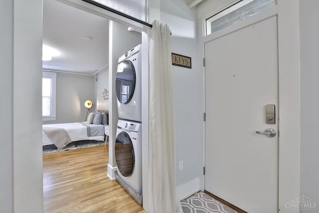 1407 Vine St Unit 303, Cincinnati, OH 45202 - laundry room featuring stacked washer / drying machine and light wood-style flooring