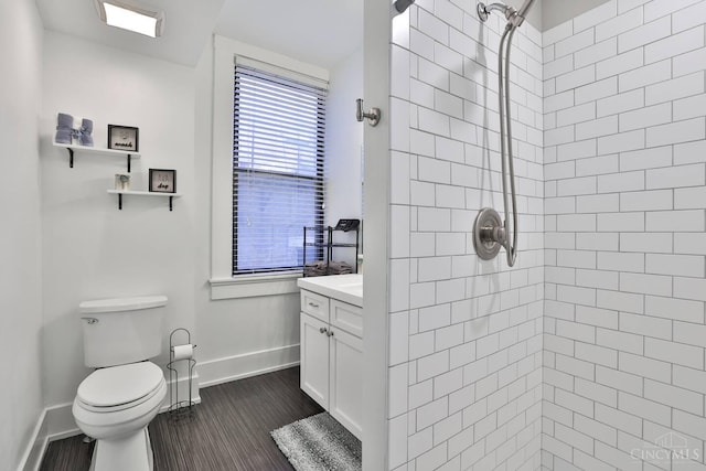 1407 Vine St Unit 303, Cincinnati, OH 45202 - bathroom featuring a tile shower, vanity, and wood finished floors