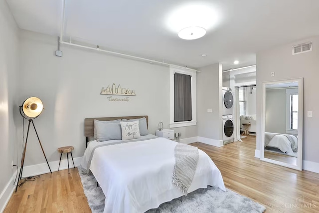 1407 Vine St Unit 303, Cincinnati, OH 45202 - bedroom with stacked washer / drying machine and light wood-type flooring