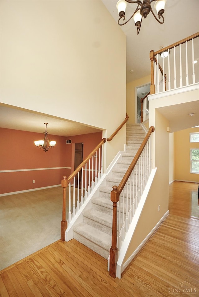 3779 Windyhollow Way, Mason, OH 45040 - staircase with a chandelier, wood finished floors, and high vaulted ceiling