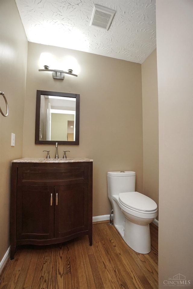3779 Windyhollow Way, Mason, OH 45040 - half bathroom with wood finished floors, vanity, and a textured ceiling