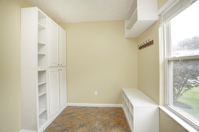 3779 Windyhollow Way, Mason, OH 45040 - mudroom featuring dark stone finish flooring and a textured ceiling