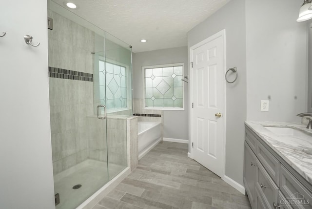 3779 Windyhollow Way, Mason, OH 45040 - bathroom featuring a garden tub, a stall shower, vanity, a textured ceiling, and recessed lighting
